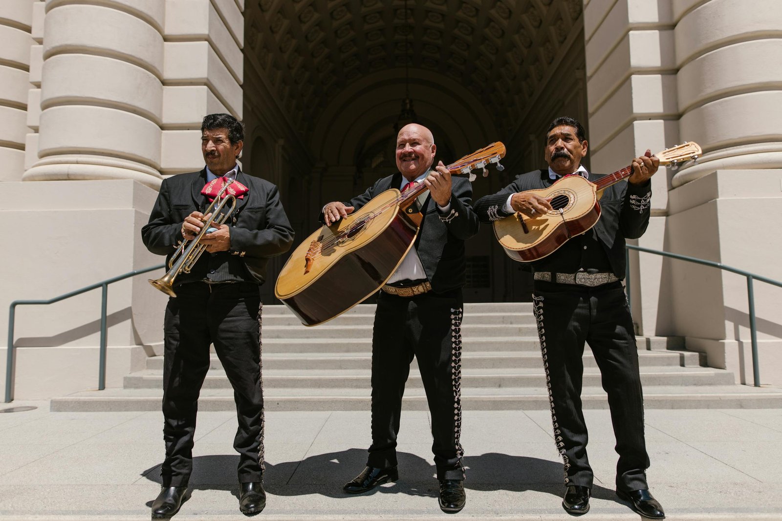 Mariachi band performing outdoors at a daylight Mexican event.